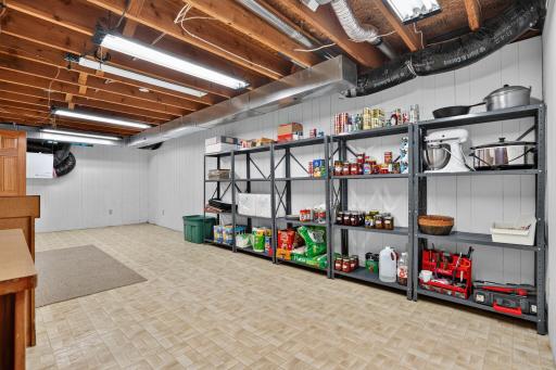 This room has a vinyl floor & well lit for canning storage or use as a shop