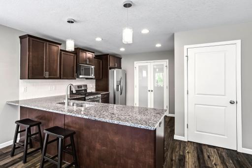 Super functional kitchen with tons of counters, cabinets, and a big walk in pantry