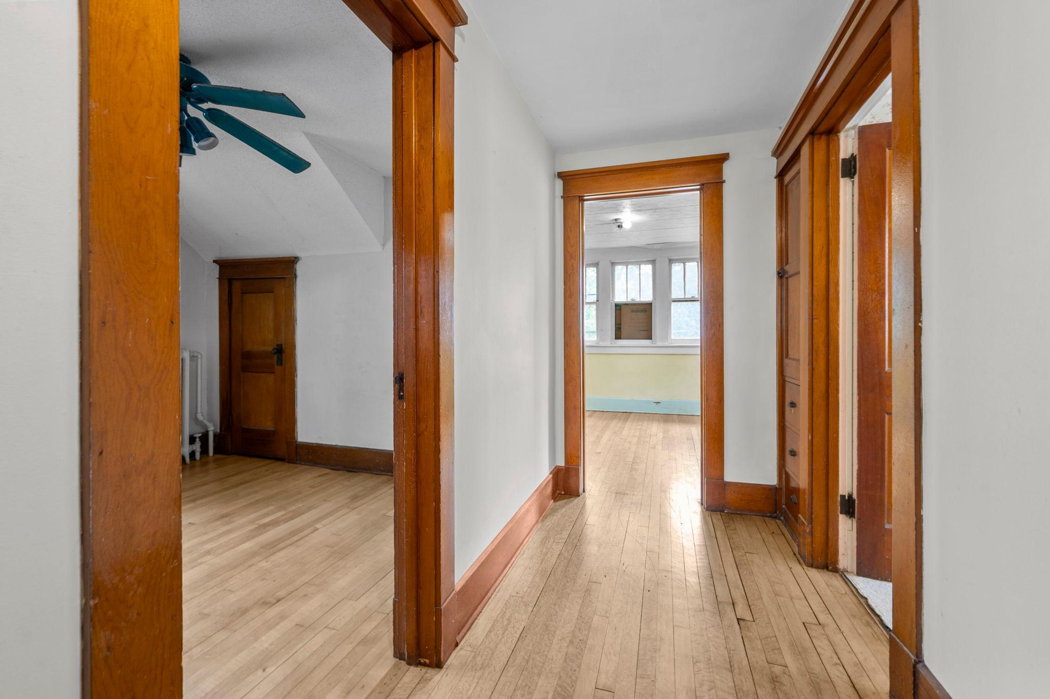 Wide hallway with built-in linen cabinet storage