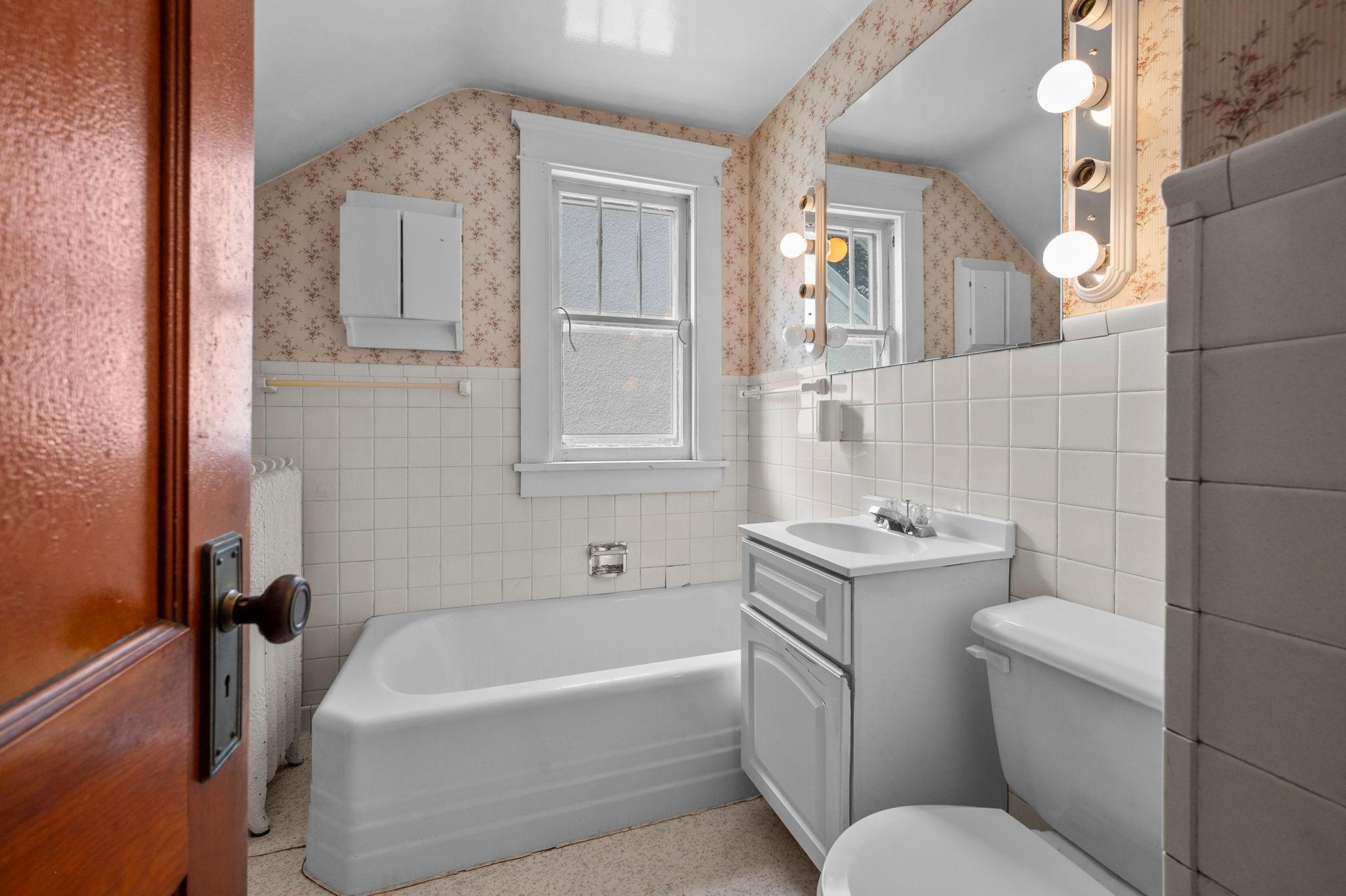 Upper level bathroom with tub, shower could be added with a fresh update.