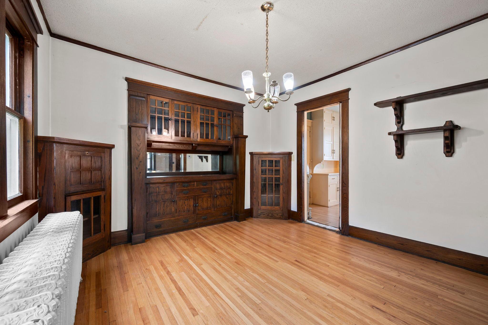 Classic dining room with curio corner cabinets with built-in desk.