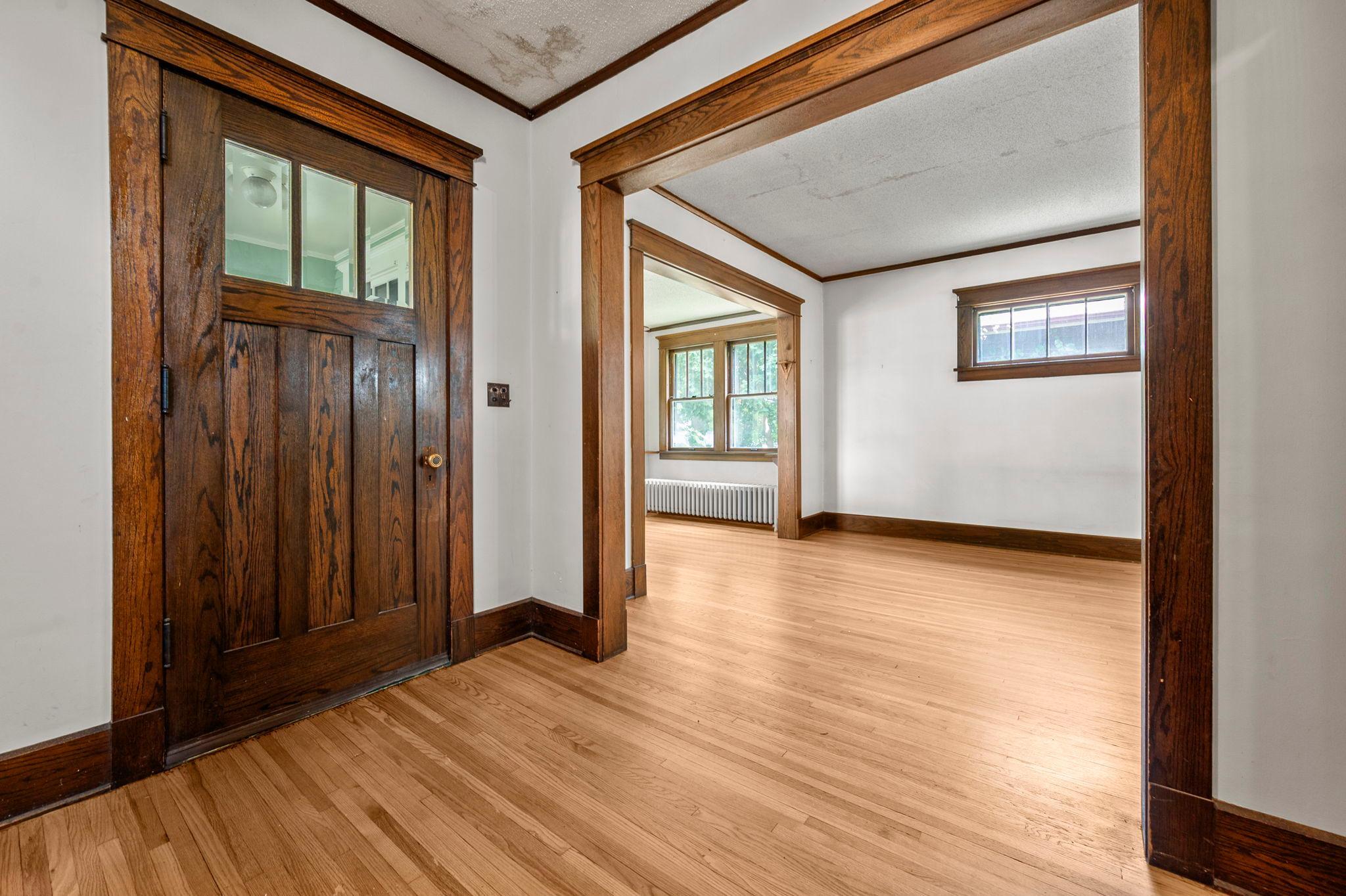 Stunning craftsman front door and rich original wood trim welcome you into sun-filled living spaces.