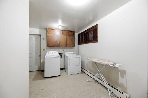 Spacious laundry room with cabinets & storagendry Room