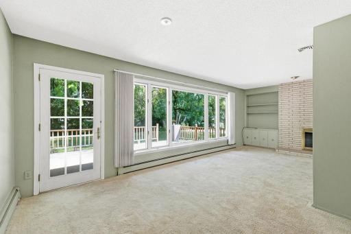 Living Room offers large windows, fireplace, built-ins and access to back deck