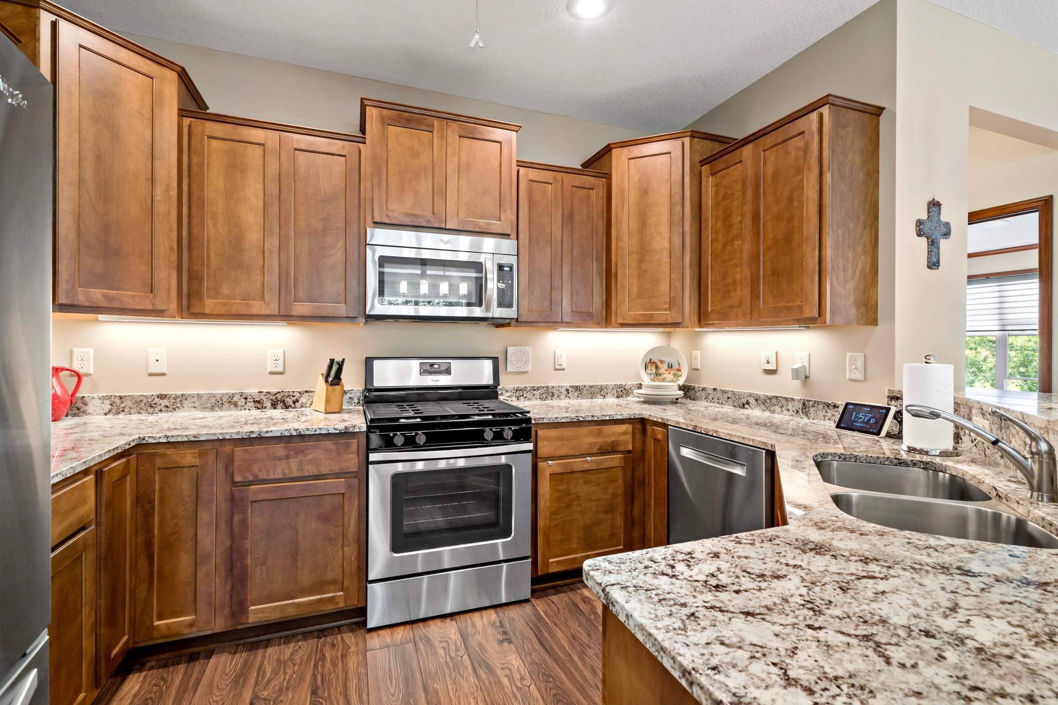 Staggered cabinetry is not only beautiful, but also offers pullout shelving in the pantry. Notice the rare gas cooktop that every chef hopes for.