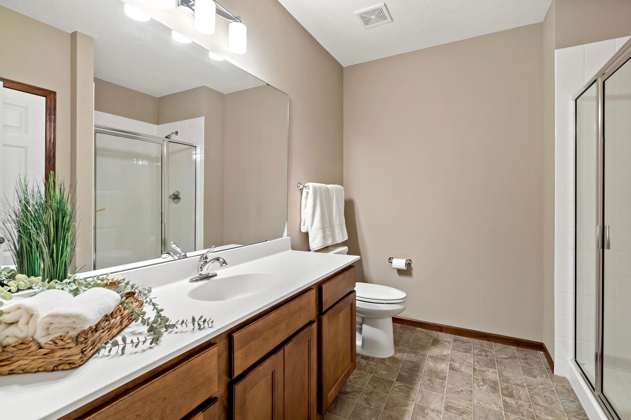 The third bathroom is oversized and conveniently located near the third bedroom. Watching the game in the lower level? No need to head upstairs every time nature calls!