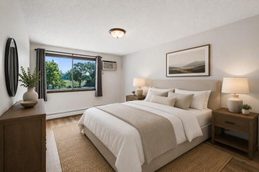 Nice view out the large window in the primary bedroom, virtually staged