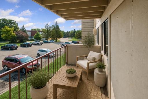 Cozy deck off of the living room, virtually staged