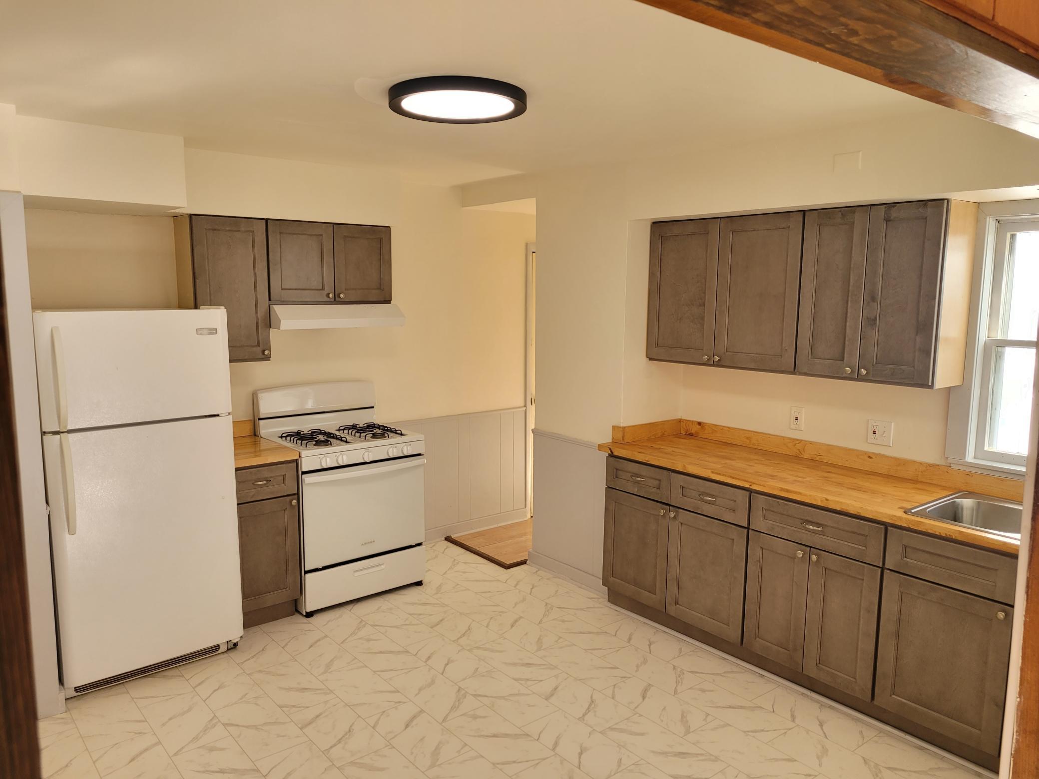 Updated kitchen cabinets, counter tops and flooring.