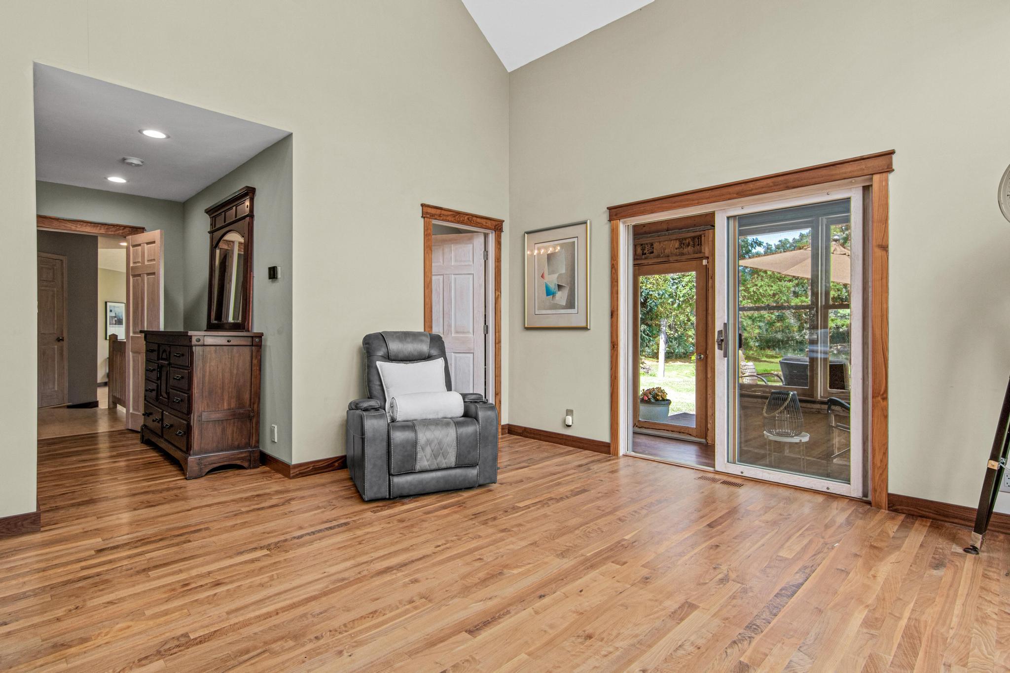 Primary Suite with sliding door to 4 season porch and deck. Walnut floors, baseboard and trim grace the entire suite.