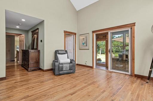 Primary Suite with sliding door to 4 season porch and deck. Walnut floors, baseboard and trim grace the entire suite.