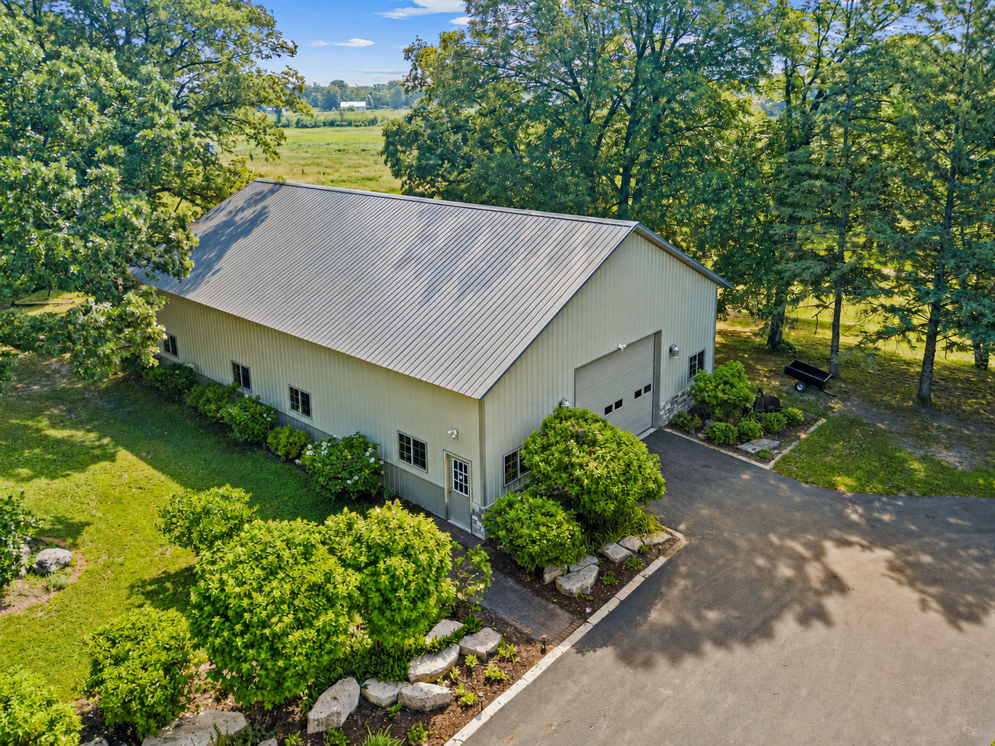 Outbuilding measure is 65'X42' and has a front and back 16'X12' garage stalls, electrically wired and the rough in is plumbed in for in floor heat. Ideal for RV's, car collectors, or storage for business. There is enough room in here for 8-10 cars!