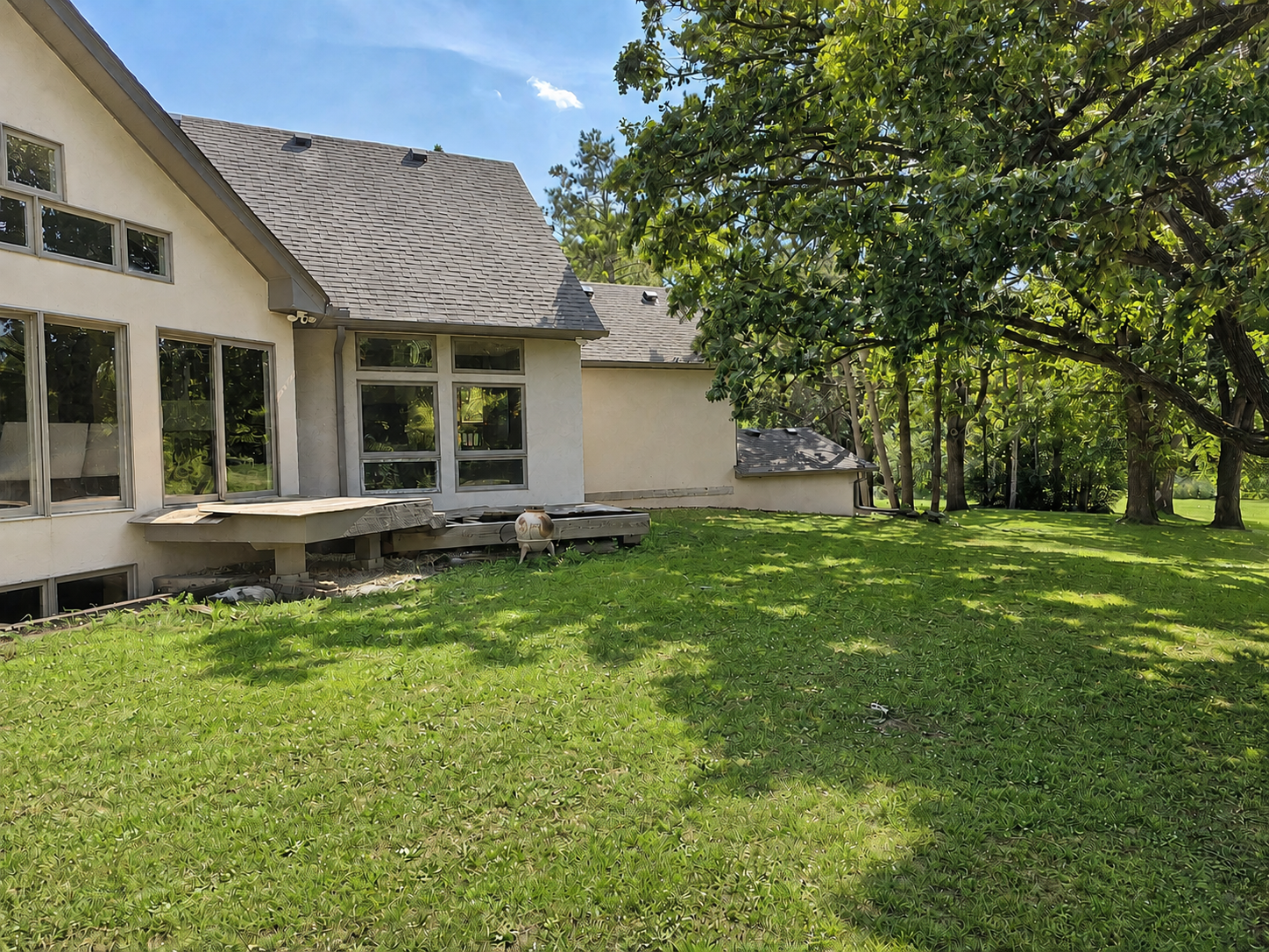 Sliding doors surround the home for enjoying the scenery. The walkout shown above is on the main floor & already has footings in place for a future deck boards. See next photo for inspiration. Currently, there are two high-quality Cumara decks.
