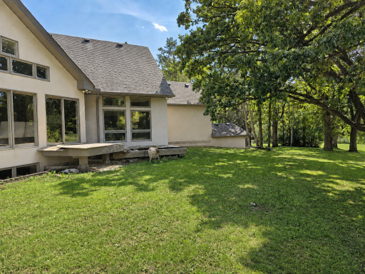 Sliding doors surround the home for enjoying the scenery. The walkout shown above is on the main floor & already has footings in place for a future deck boards. See next photo for inspiration. Currently, there are two high-quality Cumara decks.