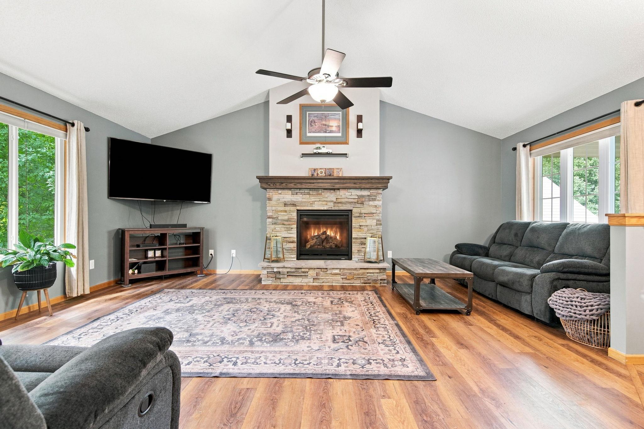 The beautiful living highlighted by a stone gas fireplace!