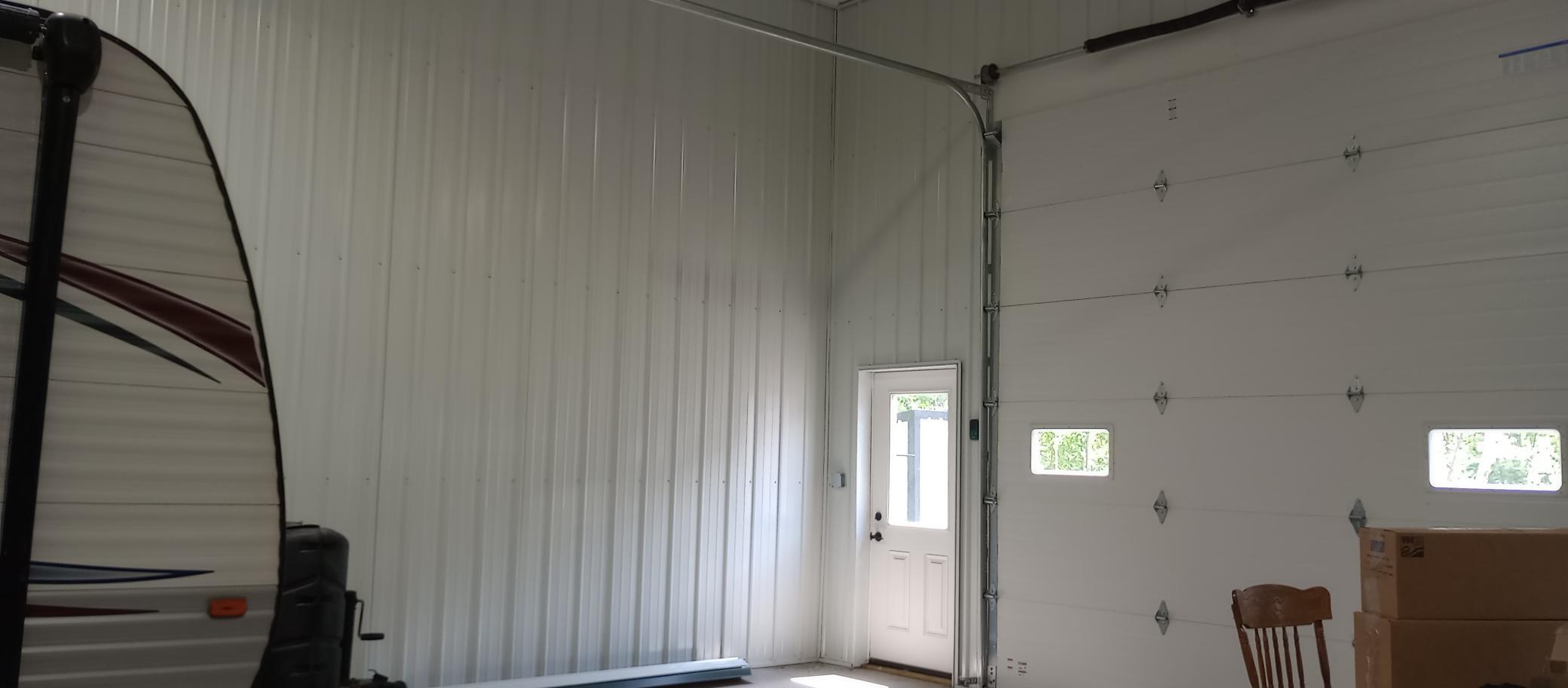Service door at SE corner of building, 12' overhead door