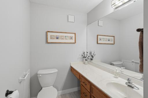 Updated powder bath with new flooring, trim and grab bars.