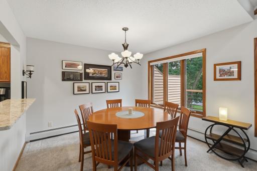 Large dining area filled with natural light and notice the breakfast bar.