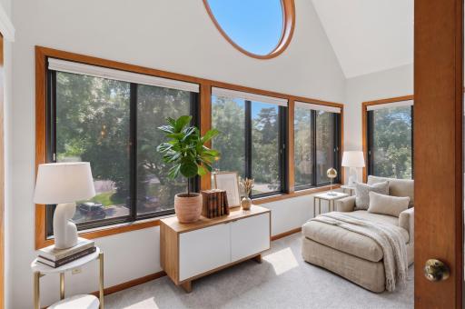 Bright and inviting sunroom filled with natural light and views of the outdoors. Virtually Staged.