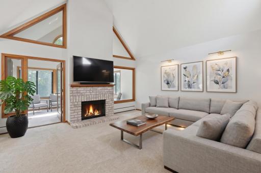 Warm and inviting living room centered around the fireplace. (Virtually staged)