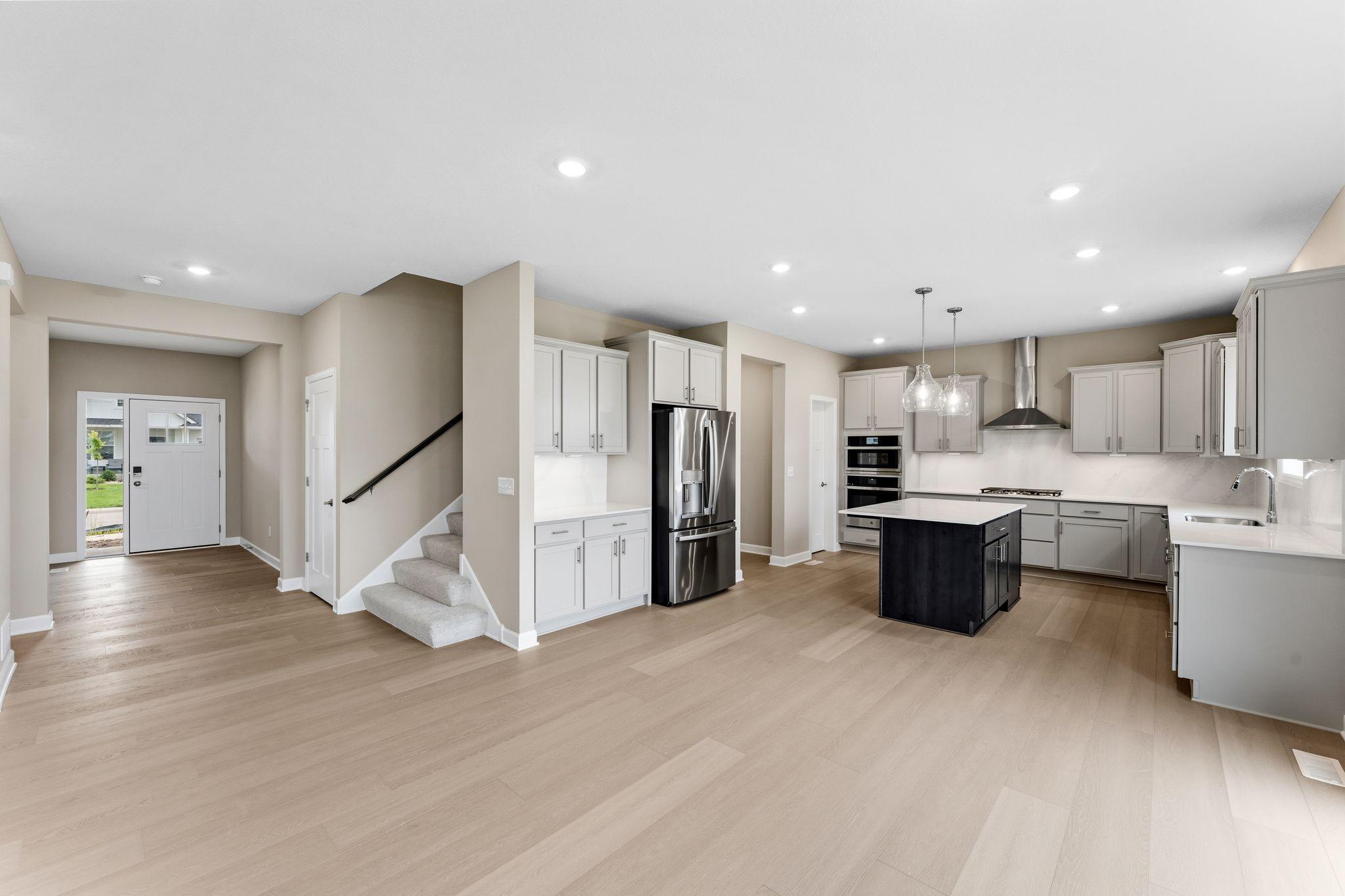 The kitchen has ease-of-access to the mudroom and flows seamlessly into the dining room