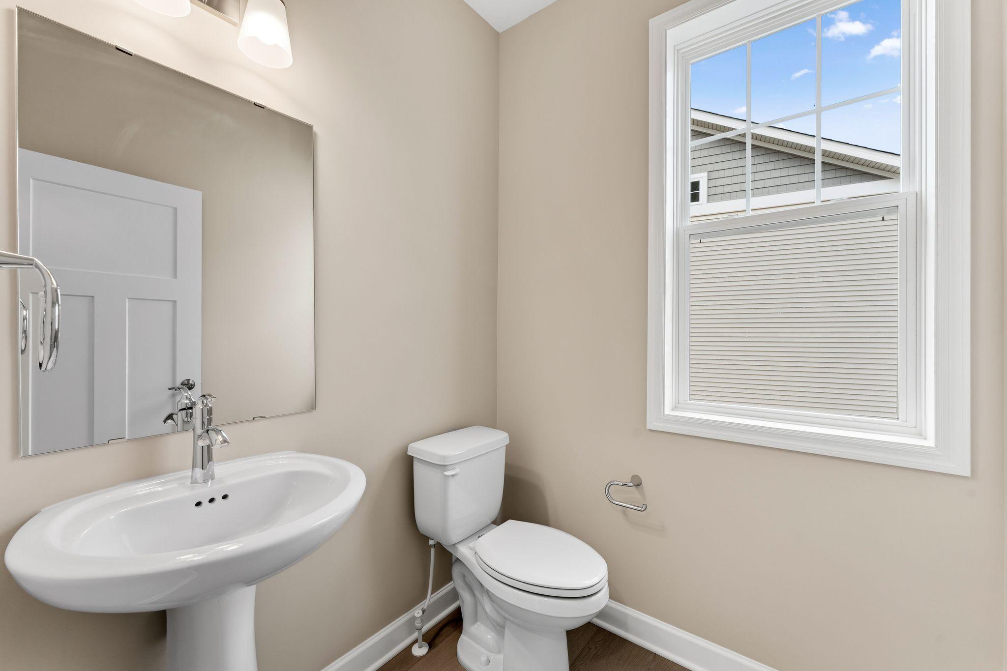 Conveniently placed near the Great Room, the powder room is conveniently trucked away with privacy in mind.