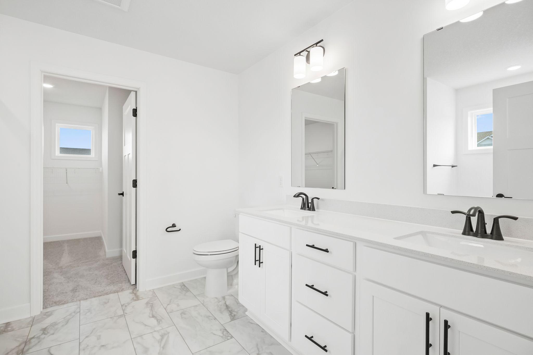 The en-suite bathroom has dual sinks to simplify any morning routine