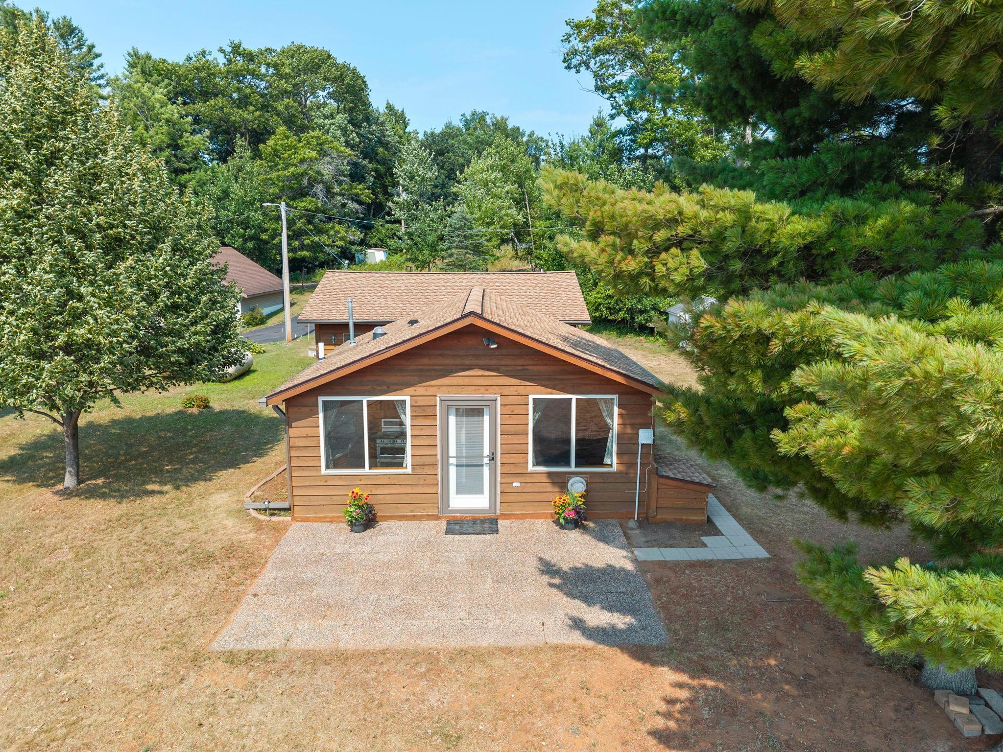 Front of the cabin with a beautiful patio area.