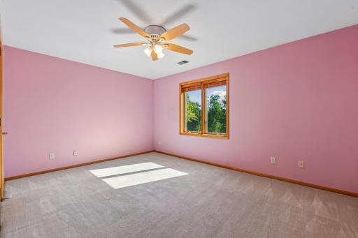 Upper level 4th bedroom that overlooks the pond and wetlands
