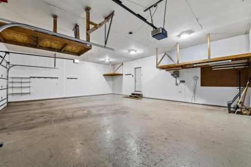 3 stall garage that was freshly painted and features an epoxied floor and storage opps