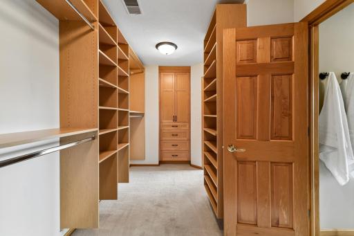 Primary Bedroom closet that flows with two entrances from the bedroom and the bathroom