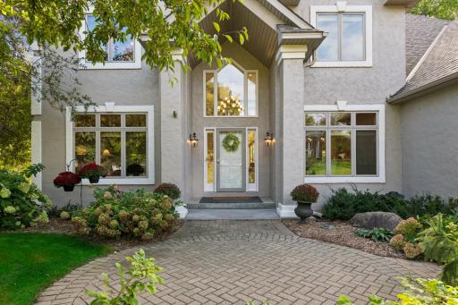 Beautiful curb appeal. The sellers installed this same style round brick special patio also in the backyard. This is a perfect place to have a cafe style table or a few adirondack chairs