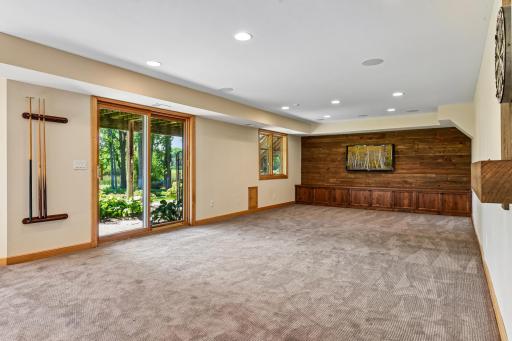 There is a small pet door that connects to a fenced in small kennel area. The special wood feature wall had a flat screen TV and has the electrical and cords behind the "Staging / fake TV" that will be removed prior to closing.