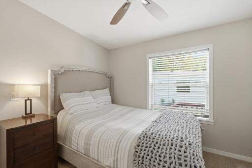 The second bedroom has two closets and a view of the side yard.