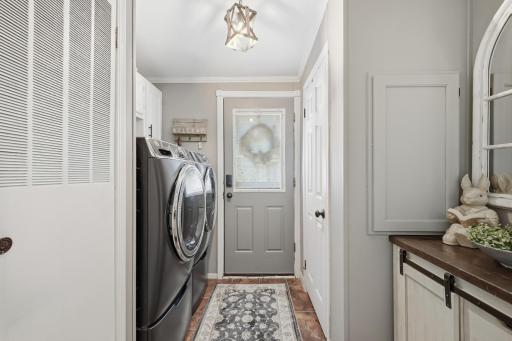 The laundry room provides alternative access to the back deck and can be used as alternative from the front door deck access. The utility access is through the door on the left. The electrical panel is behind the wall access shown on the right.