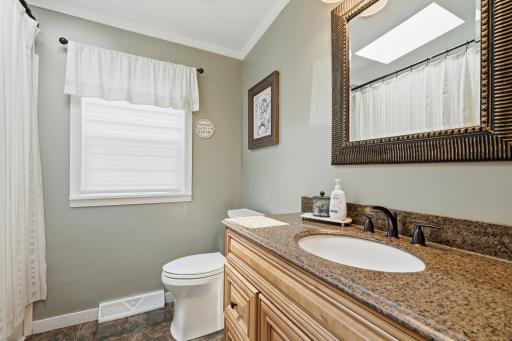 The second full bath sits between the bedrooms. Features lots of counterspace and a nice amount of storage.