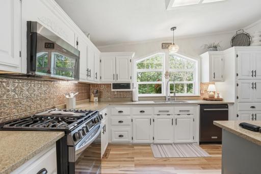 Enameled woodwork and ample storage make this kitchen a joy to cook in!