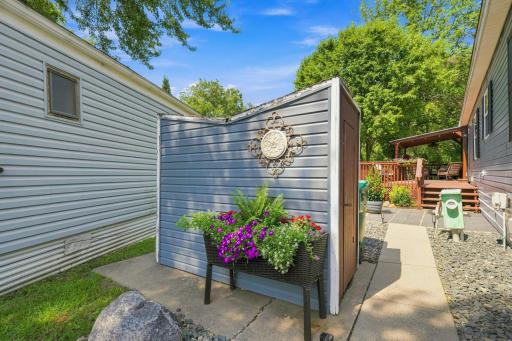 Another small storage shed to the left of the driveway.