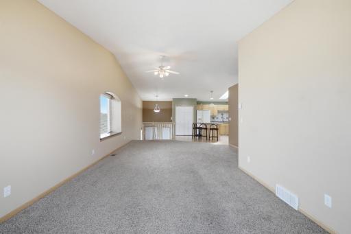Living Room offers vaulted ceilings, ceiling fan, window seat