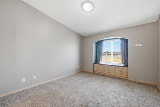 Primary offers vaulted ceilings, window seat with storage. Spacious & bright!