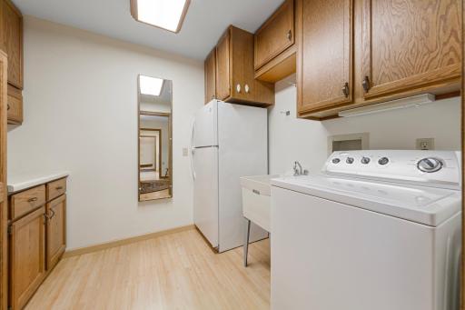 Rare in-unit laundry room with additional cabinetry and second refrigerator