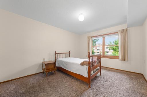 First primary suite with large window and walk-in closet