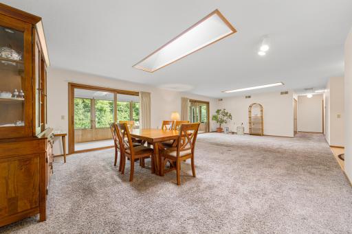 Spacious living and dining area with two skylights and access to the porch