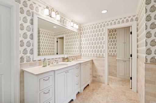 Primary bathroom features double sinks, separate tub and walk-in shower, and a walk-in closet