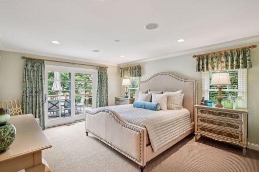 Step into the luxurious primary suite with access to the deck