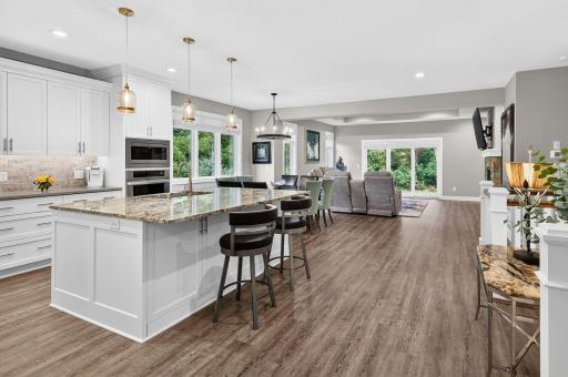 Custom cabinetry, granite center island with breakfast bar...