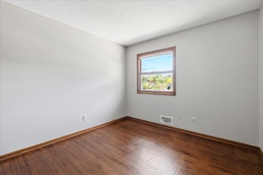 The third bedroom continues the home's timeless appeal with hardwood flooring and abundant natural light ready for your personal touch.