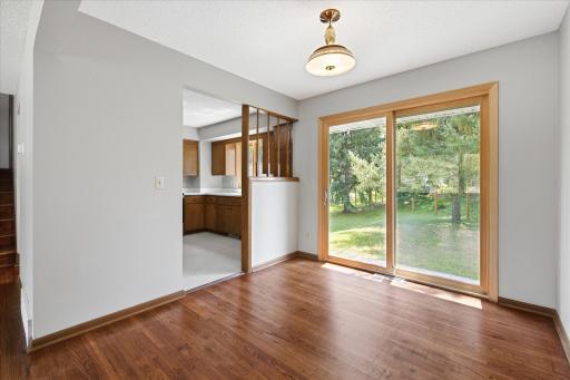 The formal dining room overlooks the backyard and features sliding glass doors that provide easy access to outdoor entertaining while filling the space with natural light.
