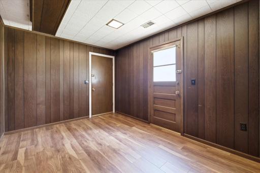 Adjacent to the family room is a versatile den or home office with its own exterior entrance, making it an excellent flex space for remote work, hobbies, guests, or additional living space.