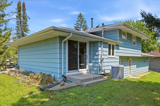 The bright transition between the interior and the expansive yard creates a seamless connection, while the home's well-maintained exterior reflects pride of ownership.